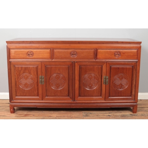 429 - A Chinese carved hardwood sideboard. Height 86.5cm, Width 153cm, Depth 48.5cm.