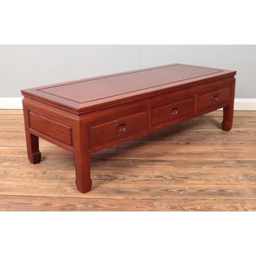 432 - A Chinese carved hardwood coffee table. Height 41cm, Width 127cm, Depth 51cm.