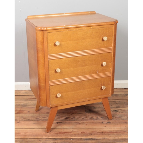 453 - A set of three hardwood drawers raised on tapered legs with ivorine handles.