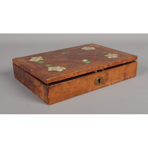 2 - A leather covered stationary box with painted and gilt decoration, fitted interior and contents of w... 