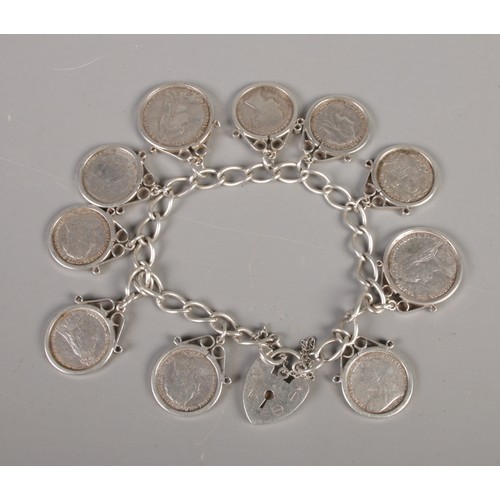 378 - A silver charm bracelet with Victorian silver coin charms. Includes 1887 six pence and various three... 