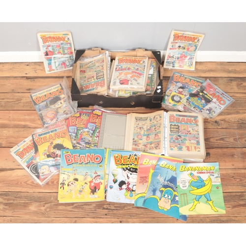 464 - A box of Beano and Dandy magazines. Includes examples with original gifts.