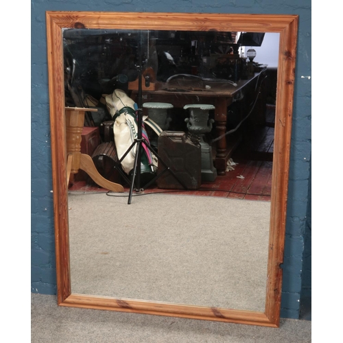 383 - A large pine framed wall mirror. (133cm x 101cm)