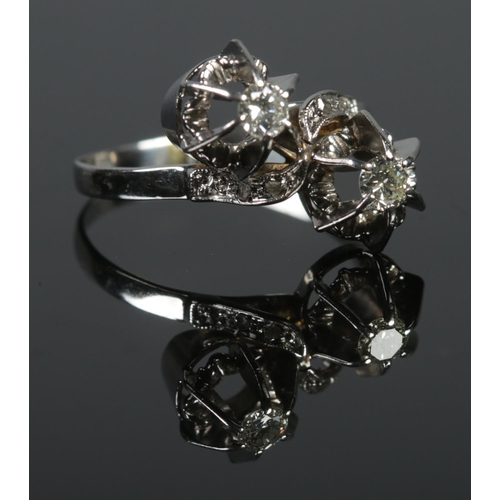 440 - An 18ct White Gold and Diamond 'moi et toi' ring. Stone sizes 1/8ct. Size O. Total weight: 3.2g.