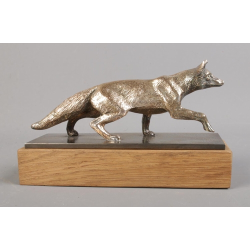 101 - A silver plated car mascot in the form of a fox mounted on plinth. Approx. length 16cm.