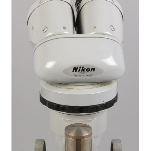 107 - A Nikon binocular microscope No. 73026.