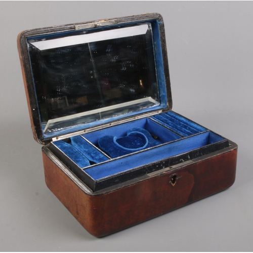 116 - A Victorian brown leather, blue silk and velvet lined dressing case; with white metal mounts and bev... 