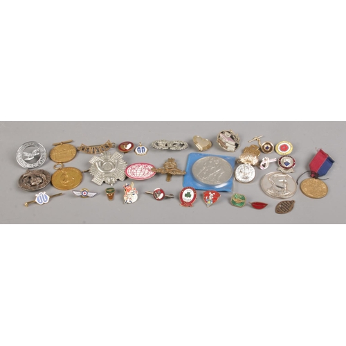 119 - A collection of assorted medals and badges, to include military and football examples.