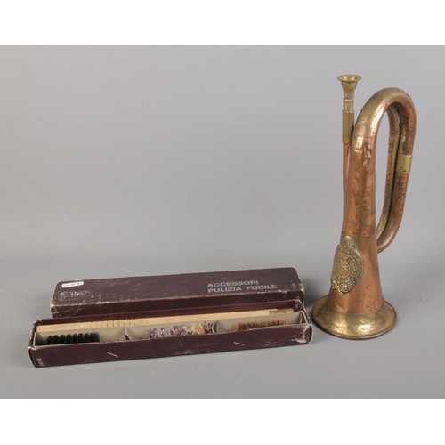 129 - An Argyll and Sutherland Bugle horn along with boxed cleaning kit.