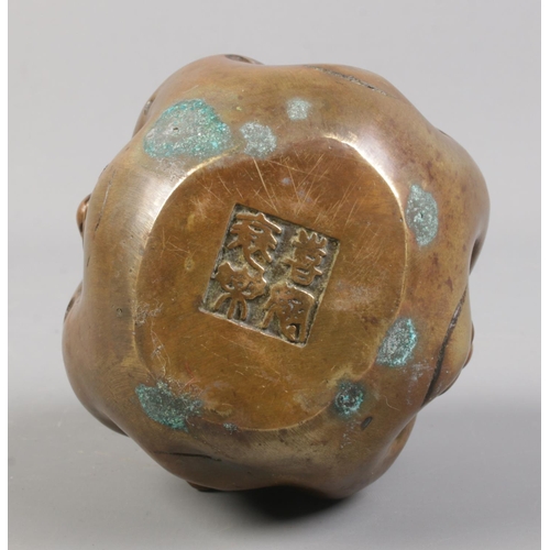 24 - An oriental bronze four face Buddha, showing happiness, sadness, joy and anger. Seal mark to base. H... 