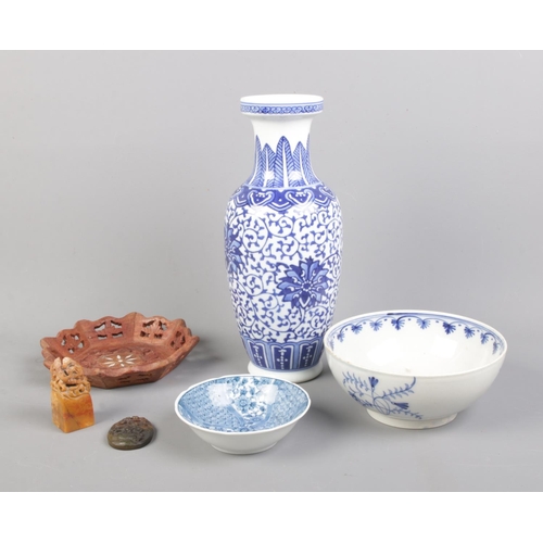 25 - A collection of oriental ware including blue and white ceramics, seal and carved dish.