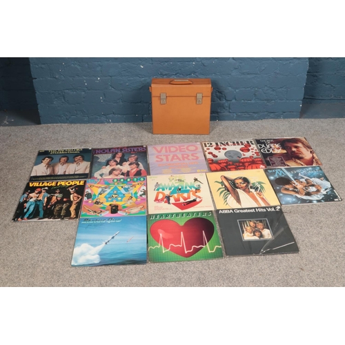 173 - A carry case containing an assortment of records, to inclkude Status Quo, Boney M, Diana Ross and Da... 