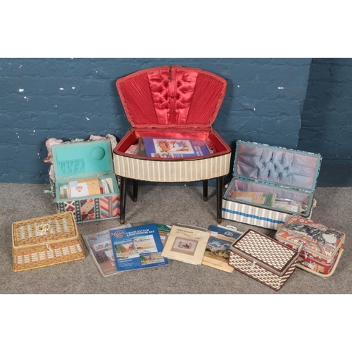 191 - A quantity of sewing baskets with contents of cross stitch kits.