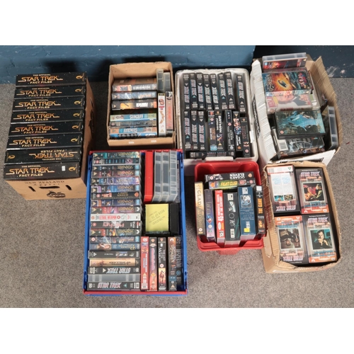 219 - A large quantity of VHS along with a box of Star Trek fact files. Includes mostly Star Trek, Horror,... 