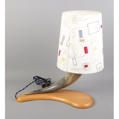 33 - A vintage horn table lamp on curved wooden base.