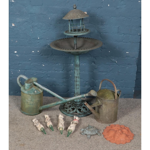 252 - A quantity of garden ornaments. Including bird bath, decorative composite meerkats, metal watering c... 