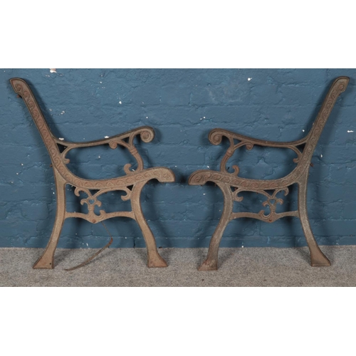 257 - A pair of cast iron bench ends.