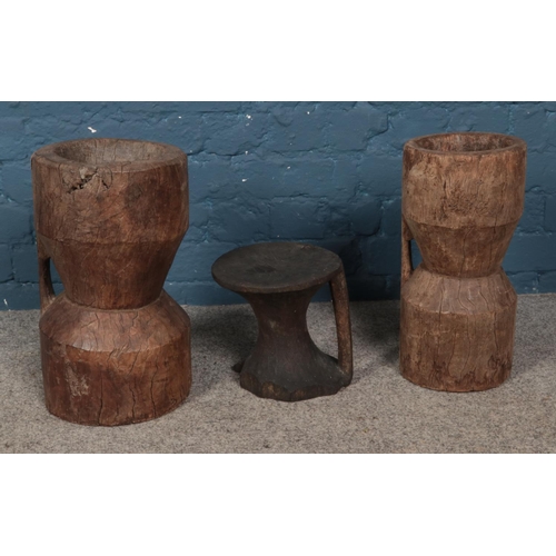 259 - Three carved African grain stompers. Tallest approx. height 41.5cm.