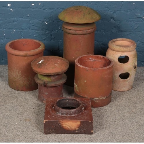 266 - A quantity of chimney pots and planters. Includes terracotta examples, etc.