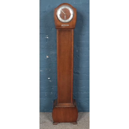 274 - A oak granddaughter clock, with arabic number dial and presentation plaque. Movement stamped for Smi... 