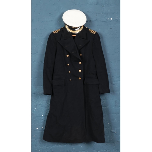 295 - A Royal Navy commanders uniform coat along with corresponding hat. Approximately 40