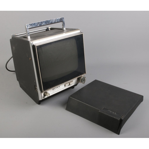 302 - A vintage Sony portable solid state television with cover.