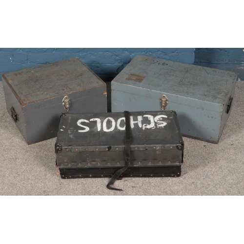 308 - Two twin handled trunks along with suitcase.