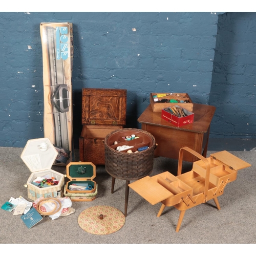 309 - A quantity of sewing equipment and knitting. Includes workboxes, Bond Classics knitting machine, bob... 