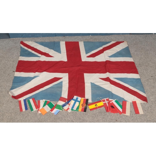 51 - A vintage linen Union Jack flag along with international flag bunting panels. Approx. dimensions 145... 