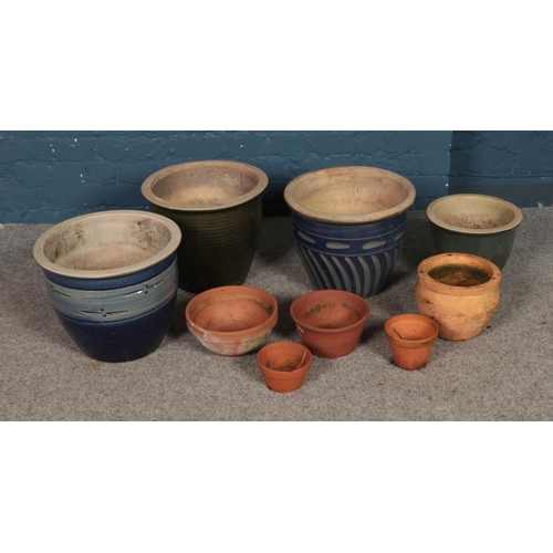 329 - A collection of terracotta planters of various sizes including blue glazed examples.