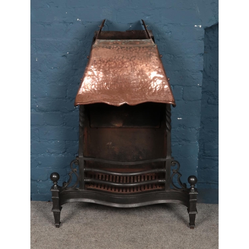 334 - A cast iron fireplace, with copper hood. 111cm tall.