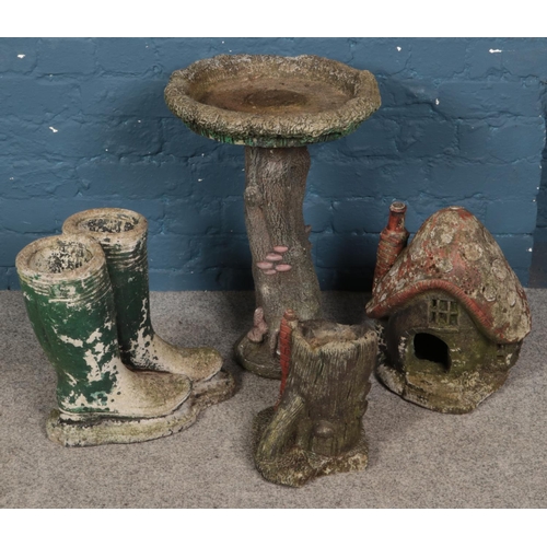 345 - A quantity of concrete garden ornaments. Includes bird bath, mushroom cottage, pair of wellington bo... 