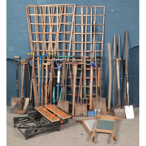 347 - A large quantity of garden tools. Includes shovels, hoes, pitchforks, hedge cutters,