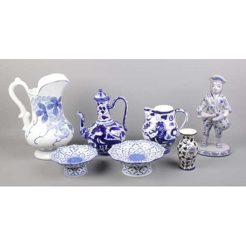 64 - A collection of blue and white ceramics, to include large jug, two pedestal bowls and drumming figur... 