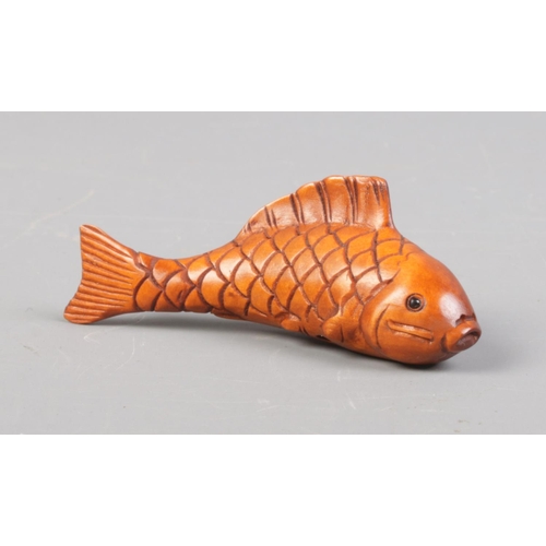 400 - A Japanese carved Netsuke in the form of a Koi carp. Signed. Approx. length 6.5cm.