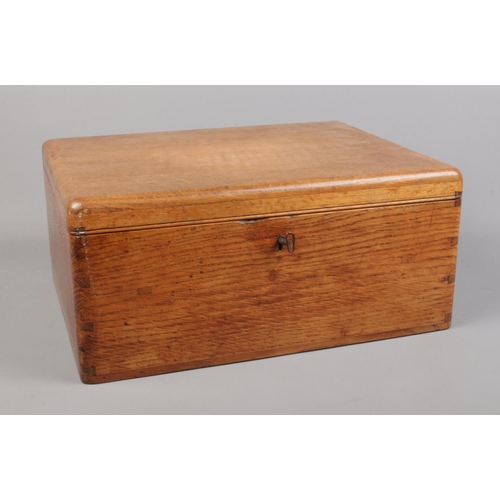 66 - An oak cased sewing box with contents of a large quantity of sewing threads.