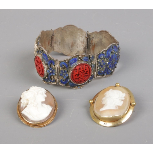 403 - Two yellow metal cameos along with a Chinese costume jewellery bracelet.