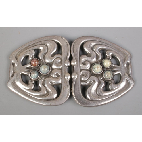 404 - A Danish silver belt buckle, set with a trio of polished stones to each side. Stamped 826 SSJ to ins... 