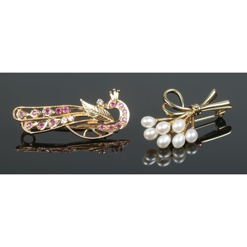 407 - Two yellow metal brooches; one formed as a peacock with ruby and paste stones, the other with pearls... 