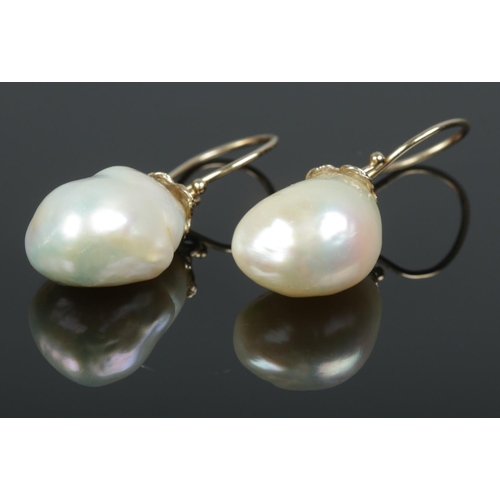 408 - A pair of 9ct Gold mounted freshwater pearl earrings. Length of pearls: 17mm.