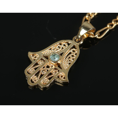 410 - Two yellow metal necklace chains, one with hamsa pendant. Total weight: 18.4g.