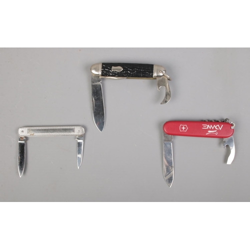 411 - Three multi bladed pocket knives, to include Richards of Sheffield and Victorinox examples. CANNOT P... 