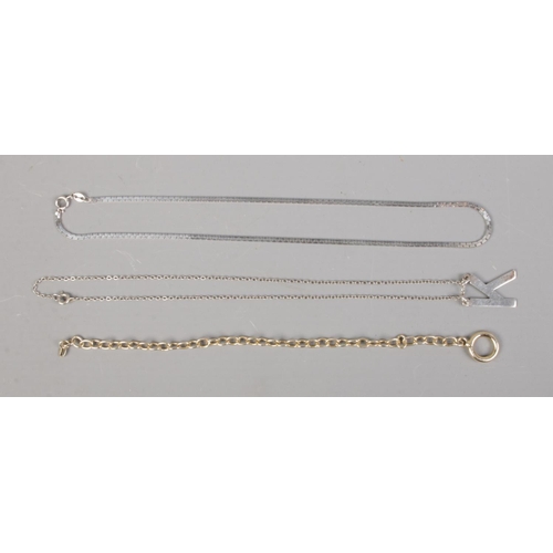 417 - Two silver necklaces, including 'K' pendant example, and one silver gilt bracelet.