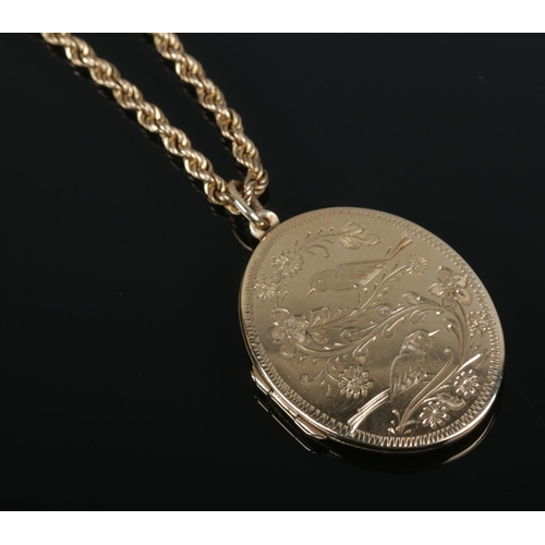 419 - A 9ct gold locket on 9ct gold chain. Locket decorated with birds and chain stamped Italy. 11.79g.