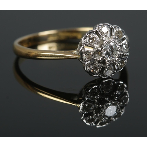 427 - A mid twentieth century 18ct Gold and Platinum Diamond cluster ring, with central brilliant cut ston... 