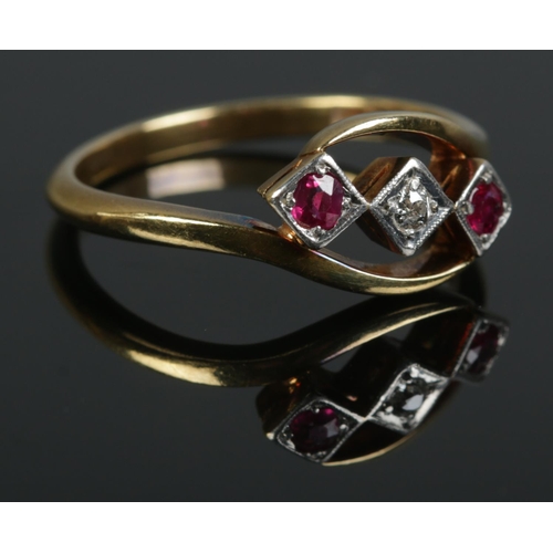 428 - An 18ct Gold and Platinum three stone Ruby and Diamond twist ring. Size U. Total weight: 4.6g