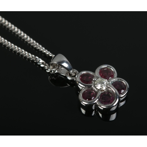 430 - A 14ct White Gold ruby and diamond floral pendant on 9ct White Gold chain. Total weight: 3.8g