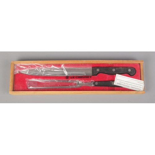 70 - A boxed Le Creuset carving set.