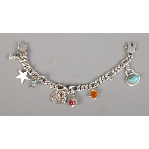 450 - Silver charm bracelet with 7 charms to include peacock and rabbit. 60.8g