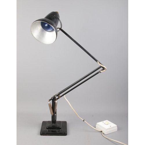 77 - A black Herbert Terry angle-poise lamp, on stepped square base.